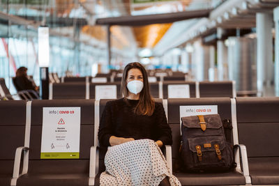 Portrait of woman sitting at airport during pandemic
