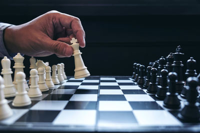 Cropped hand of businessman playing chess