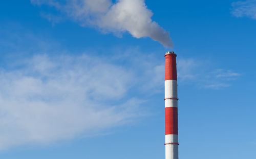 Low angle view of smoke stack against sky