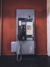 Close-up of telephone booth on wall