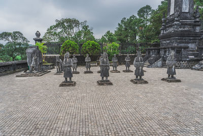 Statues at temple against sky