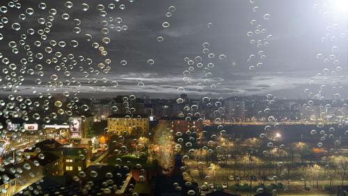 Close-up of wet city at night