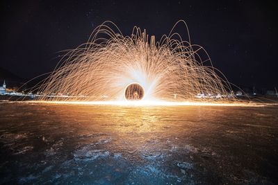 Illuminated wire wool against sky at night