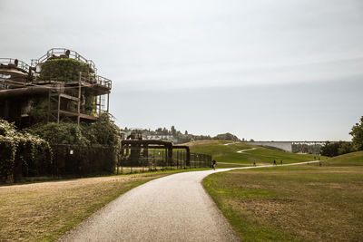 Built structure on field against sky