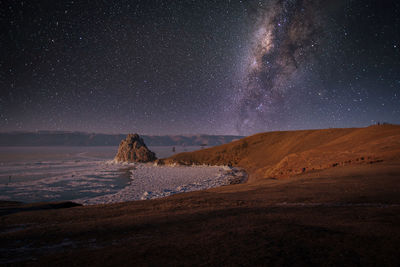 Scenic view of landscape against sky at night