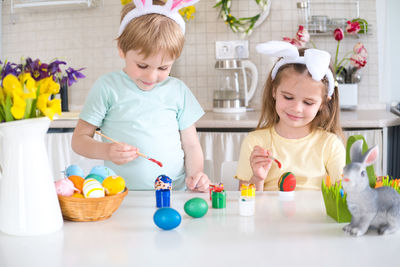 Portrait of siblings playing at home