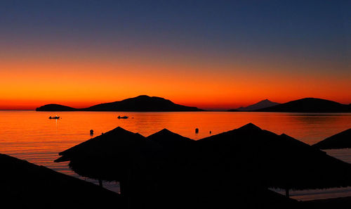 Scenic view of sea against orange sky