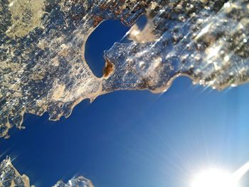 Low angle view of snow against blue sky