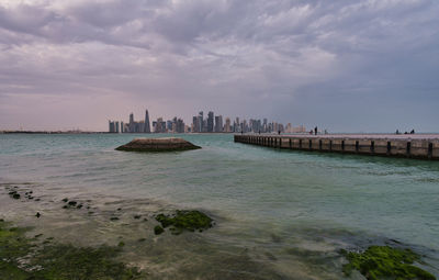 Doha skyline from the corniche promenade afternoon wide angle shot 