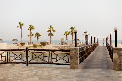 Ras al khaimah, uae - april 2022 - wooden bridge leading to the beach at cove rotana resort