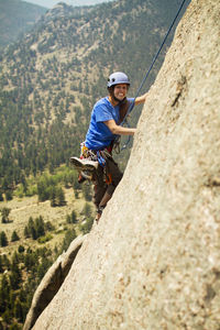 Portrait of hiker climbing mountain