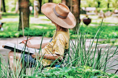 Man drawing on canvas at park