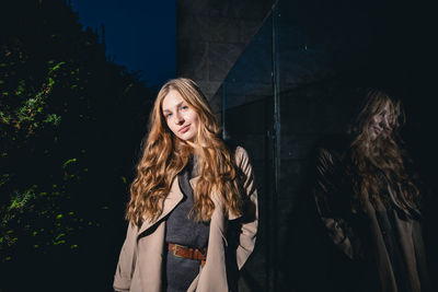 Portrait of smiling young woman standing outdoors