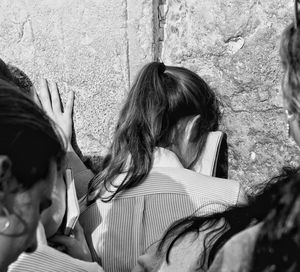 Portrait of people sitting against wall