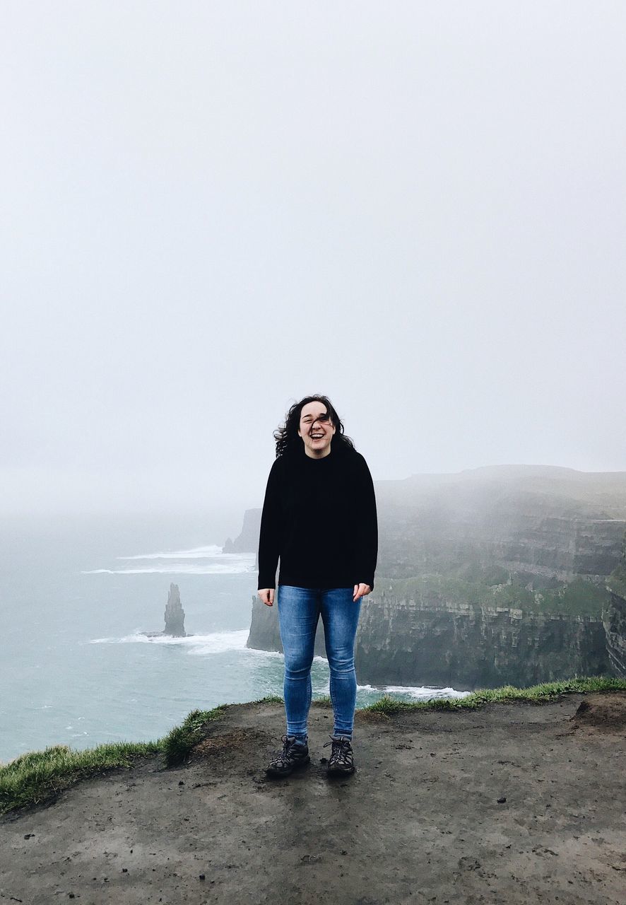 full length, casual clothing, one person, portrait, rain, one woman only, sea, adults only, people, outdoors, day, adult, nature, sky, beach, water, only women