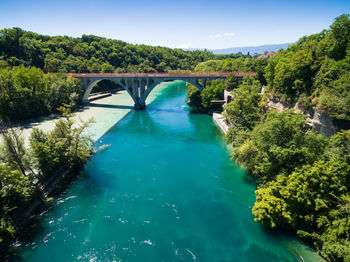 Arch bridge over river against sky