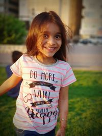 Portrait of smiling girl standing outdoors