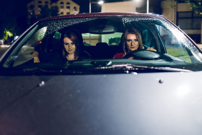 Portrait of smiling young woman in car