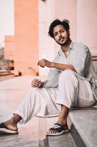 Portrait of a smiling young man sitting outdoors