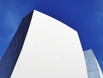 Low angle view of modern building against clear blue sky