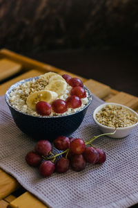 Plate of cottage cheese with granola, grapes and banana. healthy,  delicious food for breakfast