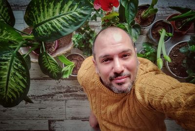 Portrait of smiling young man among plants