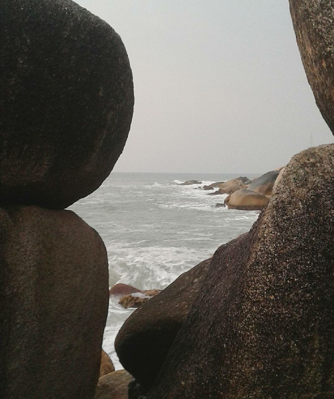 SCENIC VIEW OF SEA WITH ROCKS IN BACKGROUND