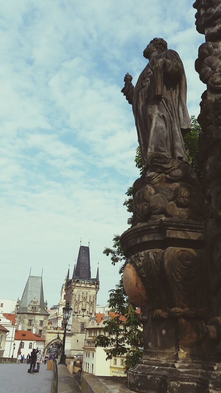 statue, sculpture, human representation, art and craft, religion, place of worship, sky, art, low angle view, spirituality, creativity, architecture, building exterior, built structure, famous place, travel destinations, history, cloud - sky