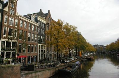 Boats in river with buildings in background
