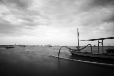 Boats moored in sea against sky