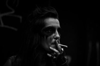 Portrait of man smoking cigarette