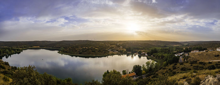 Panoramic view of trees against sky during sunset