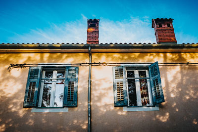 Low angle view of building against blue sky