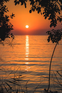 Scenic view of sea against romantic sky at sunset