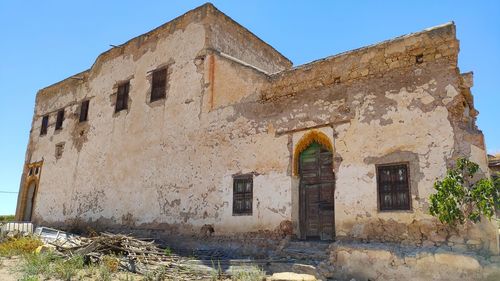 Low angle view of old building against clear sky