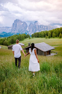 People on field against mountain range