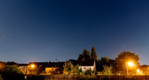 Illuminated buildings against sky at night