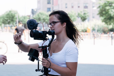 Long woman with glasses on camera