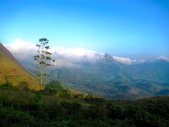 Scenic view of mountains against blue sky