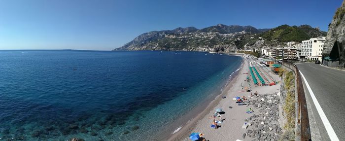 Panoramic view of beach against clear blue sky