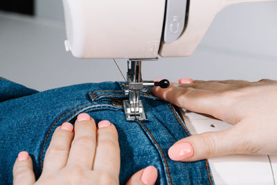 Cropped hands sewing machine