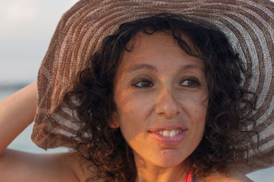 Smiling young woman wearing hat 