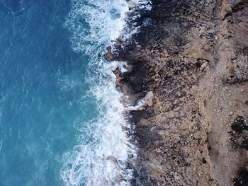 High angle view of waves on beach