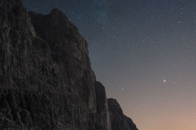 Low angle view of rocks against sky at night