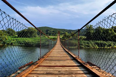 Bridge over footbridge against sky