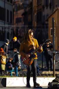 People playing guitar in city