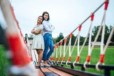 Full length of a smiling young couple against sky