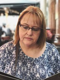 Woman reading menu at restaurant