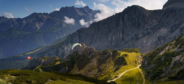 Panoramic view of mountain range against cloudy sky