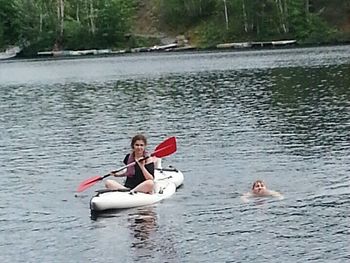 People sitting on boat in river